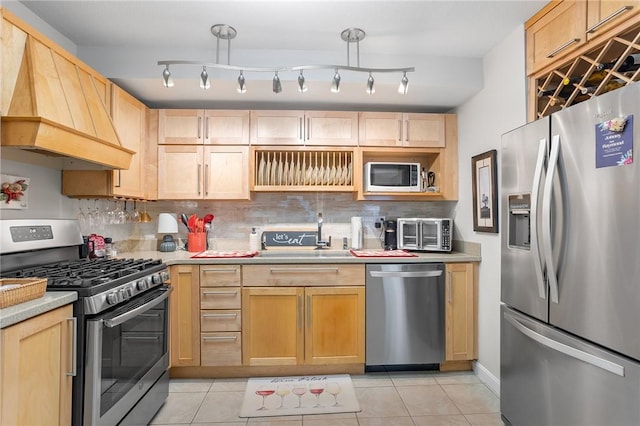 132 Hoffman Ave Unit 116, Cranston, RI 02920 - kitchen featuring appliances with stainless steel finishes, custom range hood, light brown cabinets, light countertops, and backsplash