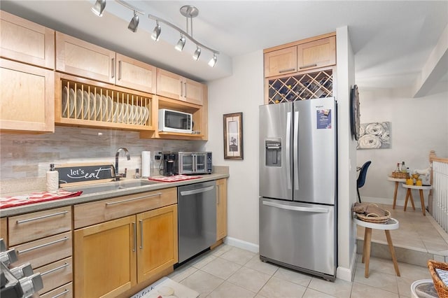 132 Hoffman Ave Unit 116, Cranston, RI 02920 - kitchen featuring stainless steel appliances, light brown cabinets, light tile patterned floors, and backsplash