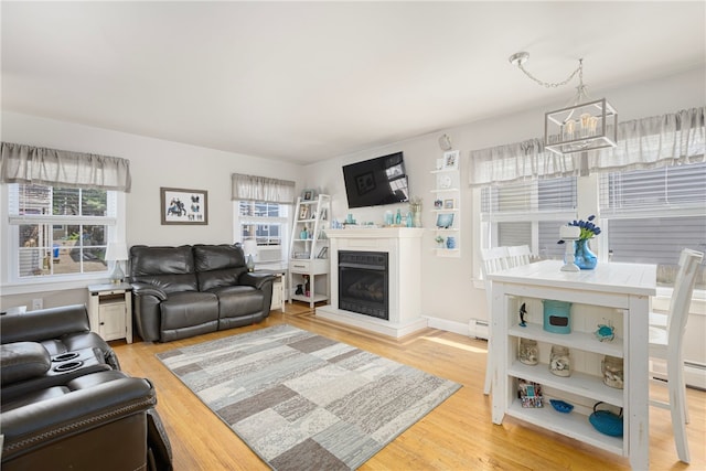 13 Vaughan Ave, Newport, RI 02840 - living area with plenty of natural light, light wood finished floors, and a glass covered fireplace