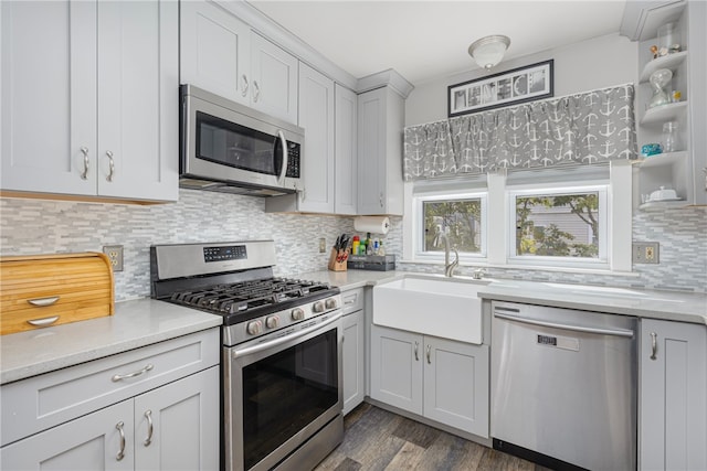 13 Vaughan Ave, Newport, RI 02840 - kitchen featuring appliances with stainless steel finishes, light countertops, dark wood-type flooring, decorative backsplash, and open shelves