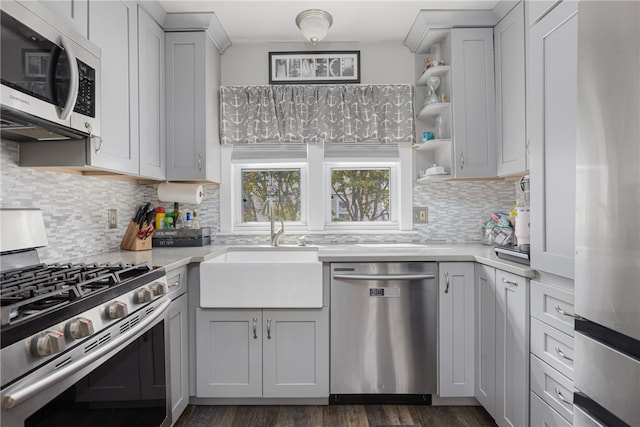 13 Vaughan Ave, Newport, RI 02840 - kitchen with appliances with stainless steel finishes, light countertops, open shelves, and dark wood-style flooring