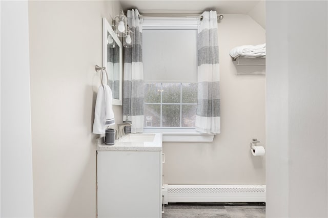 13 Vaughan Ave, Newport, RI 02840 - bathroom with a baseboard radiator, vanity, and wood finished floors