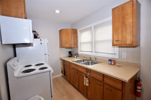92 Jefferson St, Pawtucket, RI 02860 - kitchen with white appliances, light countertops, decorative backsplash, brown cabinetry, and recessed lighting