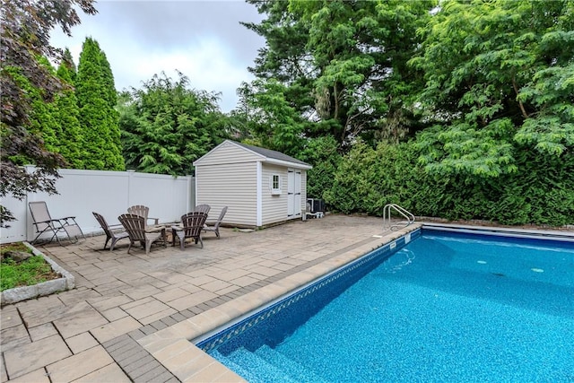 11 Greenbrier Rd, Smithfield, RI 02828 - view of swimming pool with a patio area, a fire pit, a storage shed, and view of wooded area