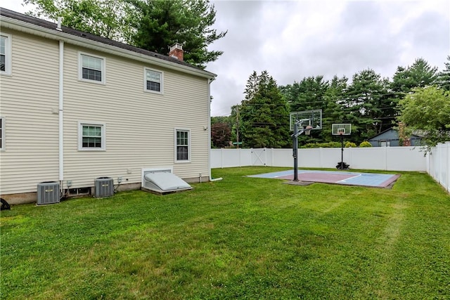 11 Greenbrier Rd, Smithfield, RI 02828 - rear view of property with a fenced backyard, basketball hoop, and a chimney