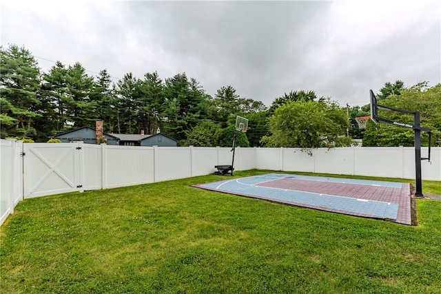 11 Greenbrier Rd, Smithfield, RI 02828 - view of basketball court featuring basketball hoop, a fenced backyard, and a gate