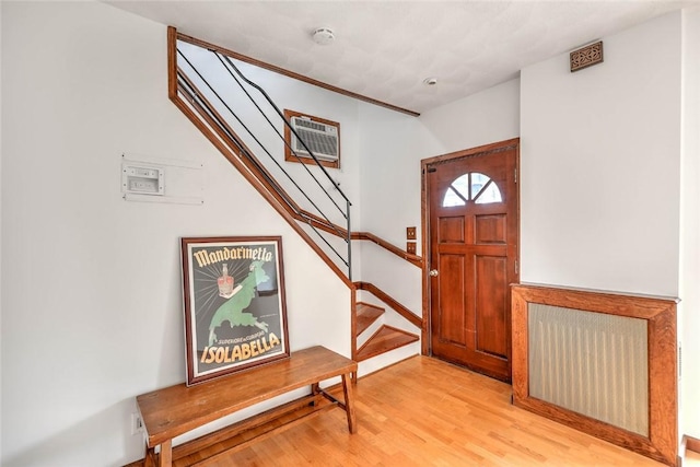 37 Denver Ave, Cranston, RI 02905 - entryway featuring an AC wall unit, stairs, and light wood finished floors