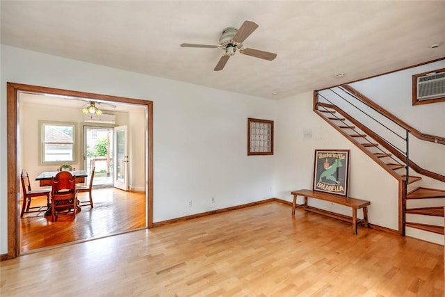 37 Denver Ave, Cranston, RI 02905 - unfurnished living room with light wood finished floors, stairway, a ceiling fan, and a wall mounted AC
