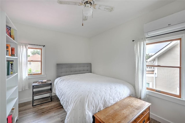 37 Denver Ave, Cranston, RI 02905 - bedroom featuring a wall mounted AC, wood finished floors, and a ceiling fan