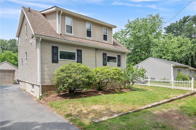 5 Harding St, Coventry, RI 02816 - view of front facade with an outdoor structure, a garage, roof with shingles, and asphalt driveway