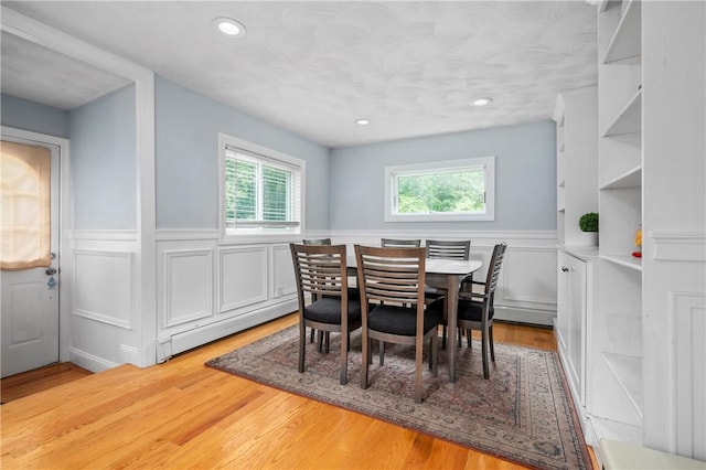 5 Harding St, Coventry, RI 02816 - dining area featuring wainscoting, light wood-type flooring, recessed lighting, a baseboard radiator, and a decorative wall