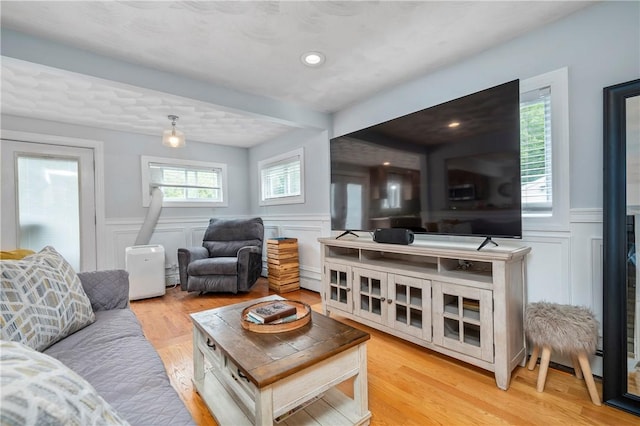 5 Harding St, Coventry, RI 02816 - living room featuring a decorative wall, wainscoting, light wood-style floors, and beamed ceiling