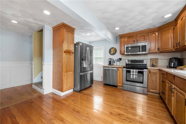 5 Harding St, Coventry, RI 02816 - kitchen with appliances with stainless steel finishes, light countertops, light wood finished floors, brown cabinets, and recessed lighting