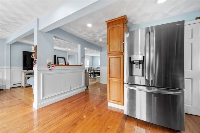 5 Harding St, Coventry, RI 02816 - kitchen with stainless steel fridge, light wood-style floors, wainscoting, a decorative wall, and recessed lighting