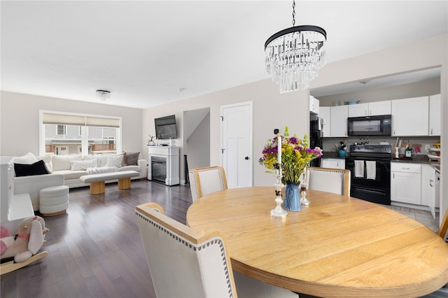 5 Jupiter Ln Unit F, Richmond, RI 02898 - dining room featuring a chandelier, wood finished floors, and a glass covered fireplace