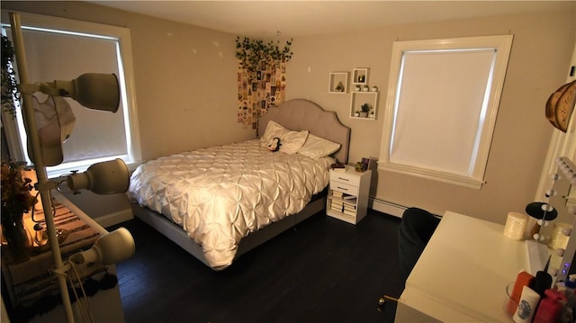 151 Hadde Ave, Cumberland, RI 02864 - bedroom with dark wood-style floors and a baseboard heating unit