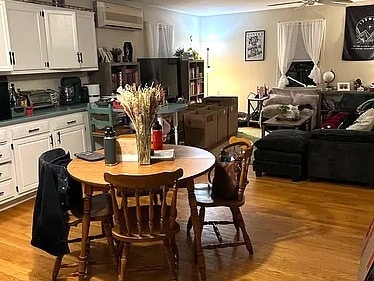 151 Hadde Ave, Cumberland, RI 02864 - dining area with a wall mounted air conditioner, wood finished floors, and a ceiling fan