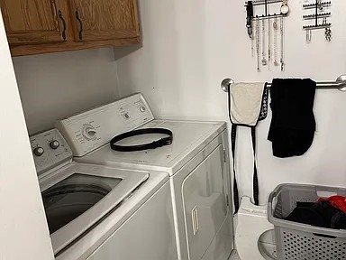 151 Hadde Ave, Cumberland, RI 02864 - washroom with washing machine and clothes dryer and cabinet space