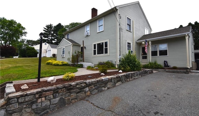 151 Hadde Ave, Cumberland, RI 02864 - view of front of house featuring a front lawn, a chimney, and cooling unit