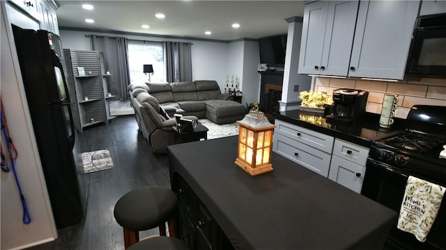 151 Hadde Ave, Cumberland, RI 02864 - kitchen featuring black appliances, dark countertops, open floor plan, dark wood-style floors, and recessed lighting