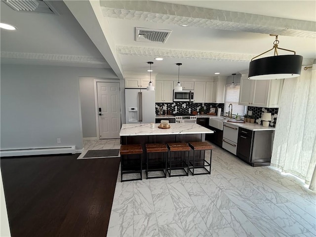 446 Angell Rd, North Providence, RI 02904 - kitchen featuring refrigerator with ice dispenser, baseboard heating, stainless steel microwave, dishwasher, and a kitchen island