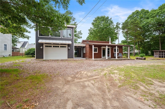 40 Alder Rd, Charlestown, RI 02813 - view of front facade with a garage, driveway, and a porch