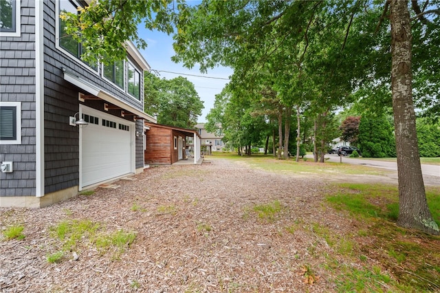 40 Alder Rd, Charlestown, RI 02813 - view of yard featuring an attached garage and driveway