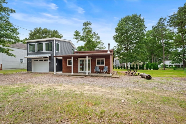40 Alder Rd, Charlestown, RI 02813 - view of front of house featuring an attached garage, a porch, gravel driveway, and a front yard