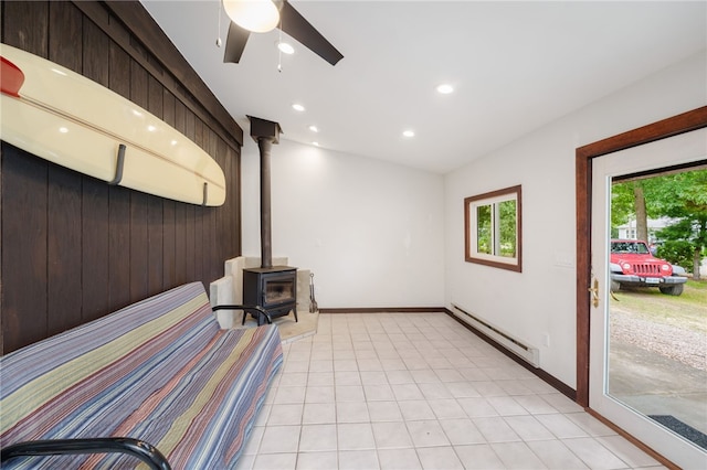 40 Alder Rd, Charlestown, RI 02813 - unfurnished bedroom featuring baseboard heating, a wood stove, recessed lighting, light tile patterned flooring, and ceiling fan