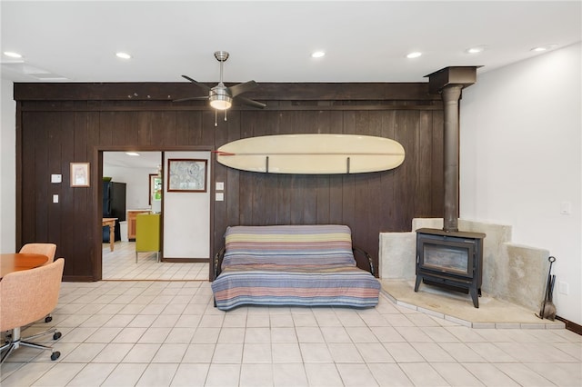 40 Alder Rd, Charlestown, RI 02813 - bedroom featuring a wood stove, light tile patterned flooring, recessed lighting, and wood walls