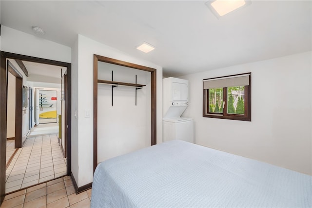 40 Alder Rd, Charlestown, RI 02813 - bedroom featuring stacked washer / drying machine, a closet, and light tile patterned floors