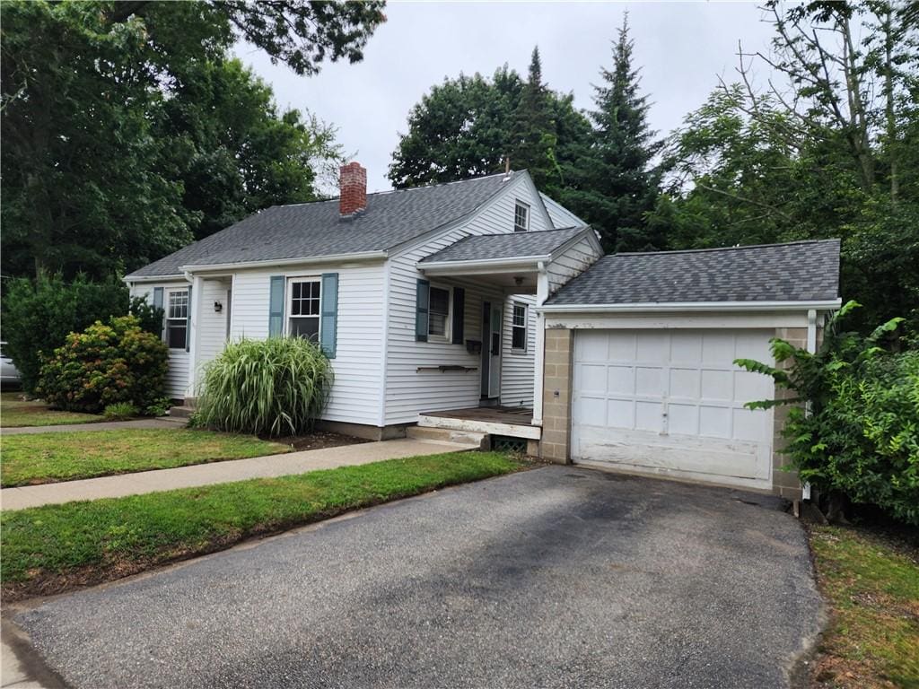 135 George Waterman Rd, Johnston, RI 02919 - single story home with a chimney, driveway, an attached garage, and roof with shingles