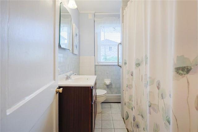 162 Rand St, Central Falls, RI 02863 - bathroom featuring tile patterned flooring, vanity, tile walls, curtained shower, and wainscoting