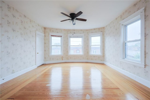 162 Rand St, Central Falls, RI 02863 - spare room featuring light wood-type flooring, wallpapered walls, and ceiling fan