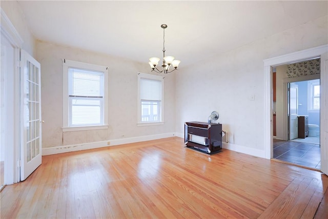 162 Rand St, Central Falls, RI 02863 - unfurnished living room featuring a chandelier and wood finished floors