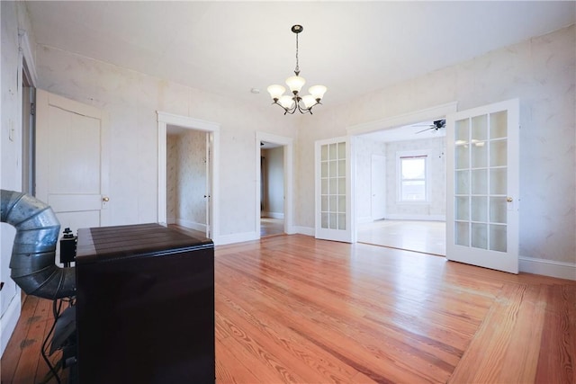 162 Rand St, Central Falls, RI 02863 - unfurnished dining area with french doors, a chandelier, and light wood-type flooring