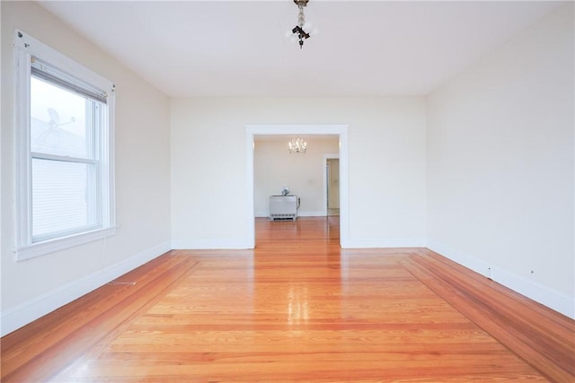 162 Rand St, Central Falls, RI 02863 - empty room with a chandelier and light wood finished floors