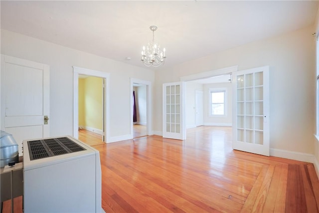 162 Rand St, Central Falls, RI 02863 - unfurnished dining area with french doors, a chandelier, and light wood-style flooring