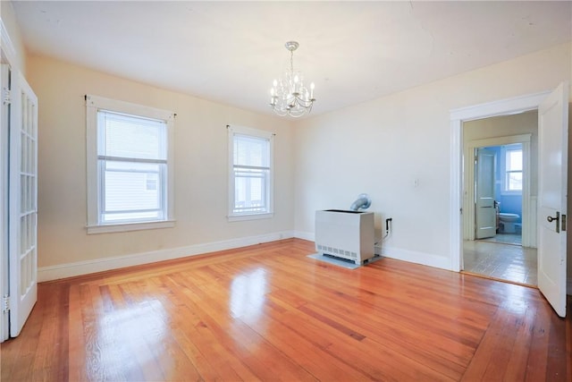 162 Rand St, Central Falls, RI 02863 - unfurnished room with a chandelier, light wood-type flooring, and heating unit