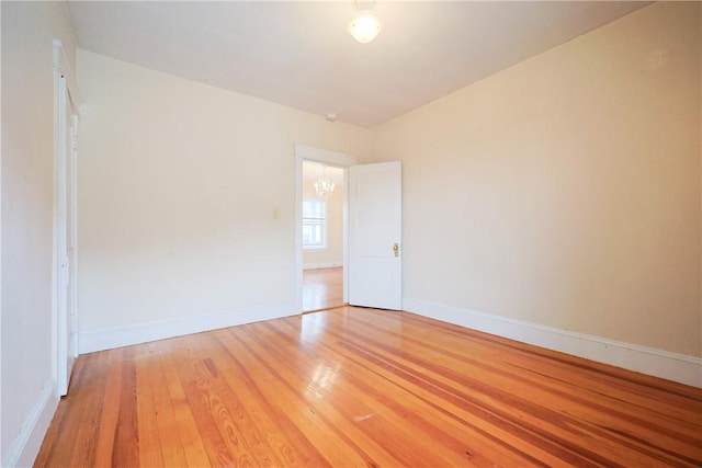 162 Rand St, Central Falls, RI 02863 - unfurnished room with light wood finished floors and a chandelier