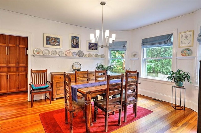 179 Elmgrove Ave, Providence, RI 02906 - dining room with a chandelier and light wood-style floors