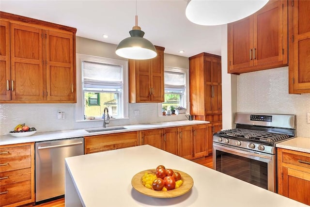 179 Elmgrove Ave, Providence, RI 02906 - kitchen with appliances with stainless steel finishes, decorative backsplash, light countertops, decorative light fixtures, and light wood-type flooring