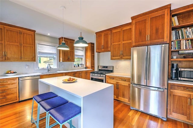 179 Elmgrove Ave, Providence, RI 02906 - kitchen featuring stainless steel appliances, light wood-type flooring, light countertops, and decorative backsplash