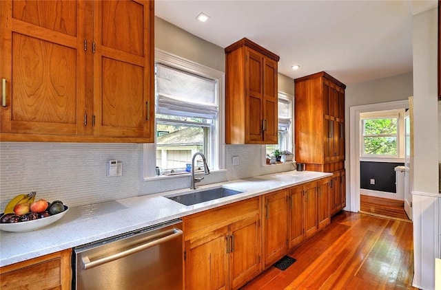 179 Elmgrove Ave, Providence, RI 02906 - kitchen with stainless steel dishwasher, dark wood-style floors, tasteful backsplash, brown cabinets, and recessed lighting