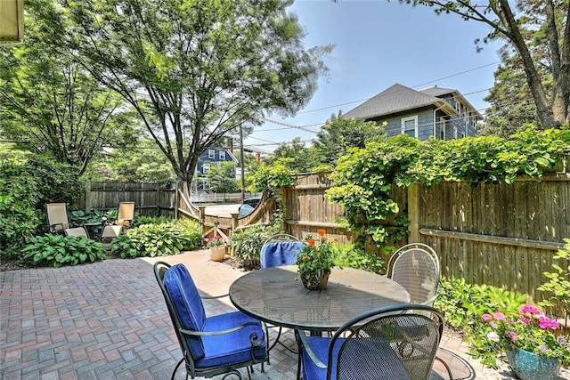 179 Elmgrove Ave, Providence, RI 02906 - fenced backyard featuring a patio area and outdoor dining space