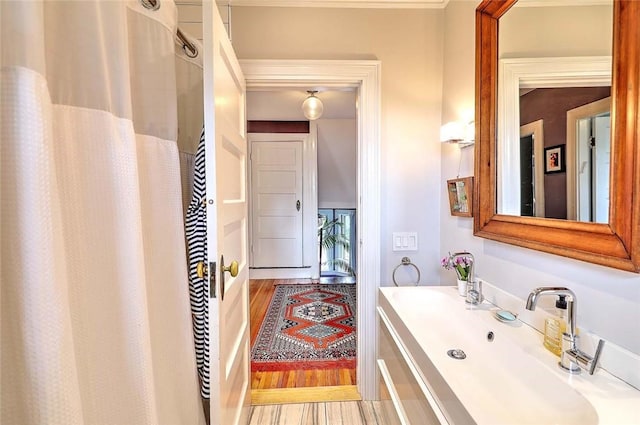 179 Elmgrove Ave, Providence, RI 02906 - full bathroom with a shower with shower curtain, vanity, and wood finished floors