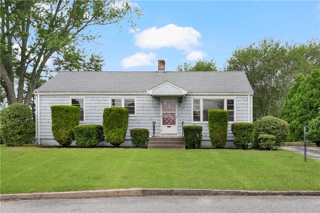 21 Parsonage Dr, Warwick, RI 02889 - view of front of home with a chimney and a front yard
