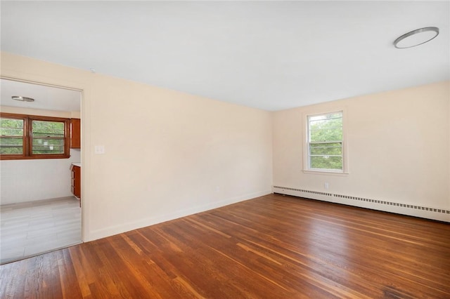 21 Parsonage Dr, Warwick, RI 02889 - empty room with a baseboard heating unit and wood finished floors