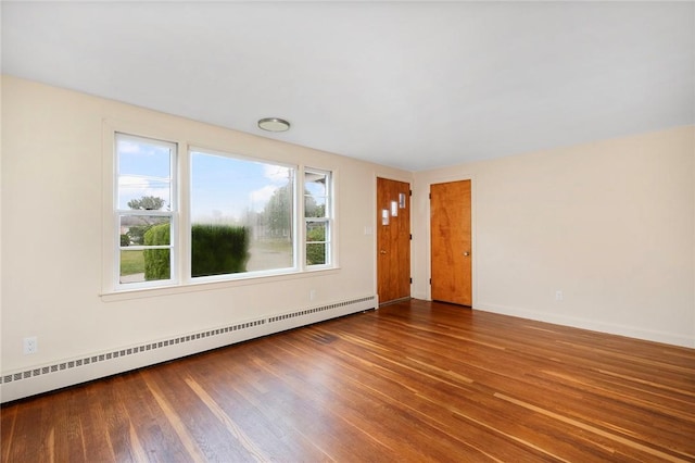 21 Parsonage Dr, Warwick, RI 02889 - empty room with a baseboard heating unit, healthy amount of natural light, and wood finished floors