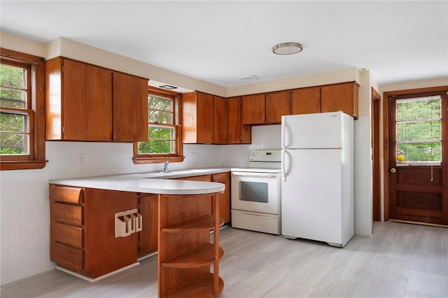 21 Parsonage Dr, Warwick, RI 02889 - kitchen featuring white appliances, brown cabinets, healthy amount of natural light, and light countertops